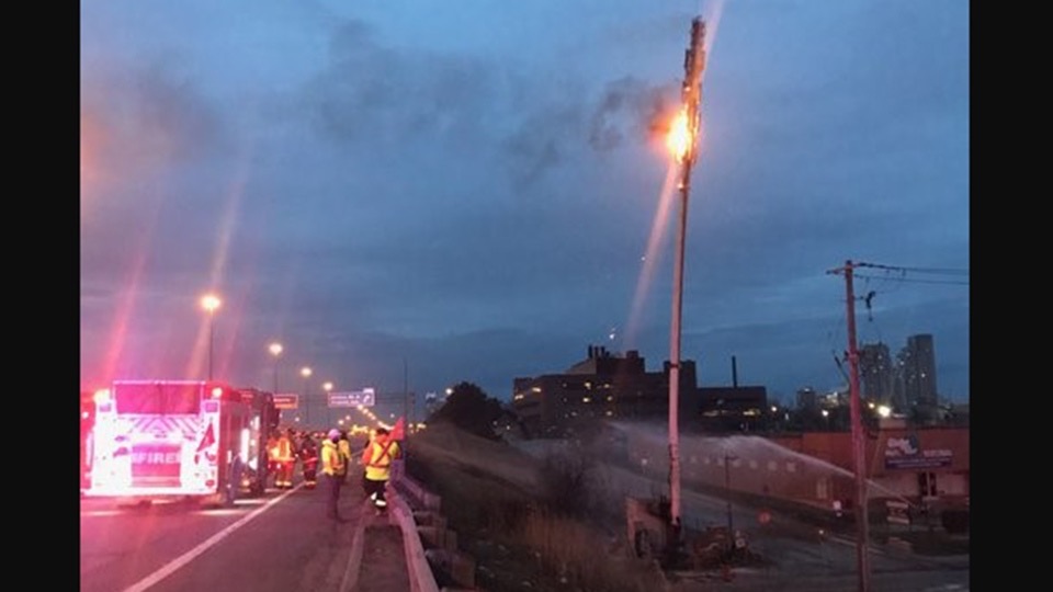 Fire crews battle brushfire ignited by a burning cell phone tower along Highway 401 in Scarborough, Ontario (March 31, 2021) -OPP